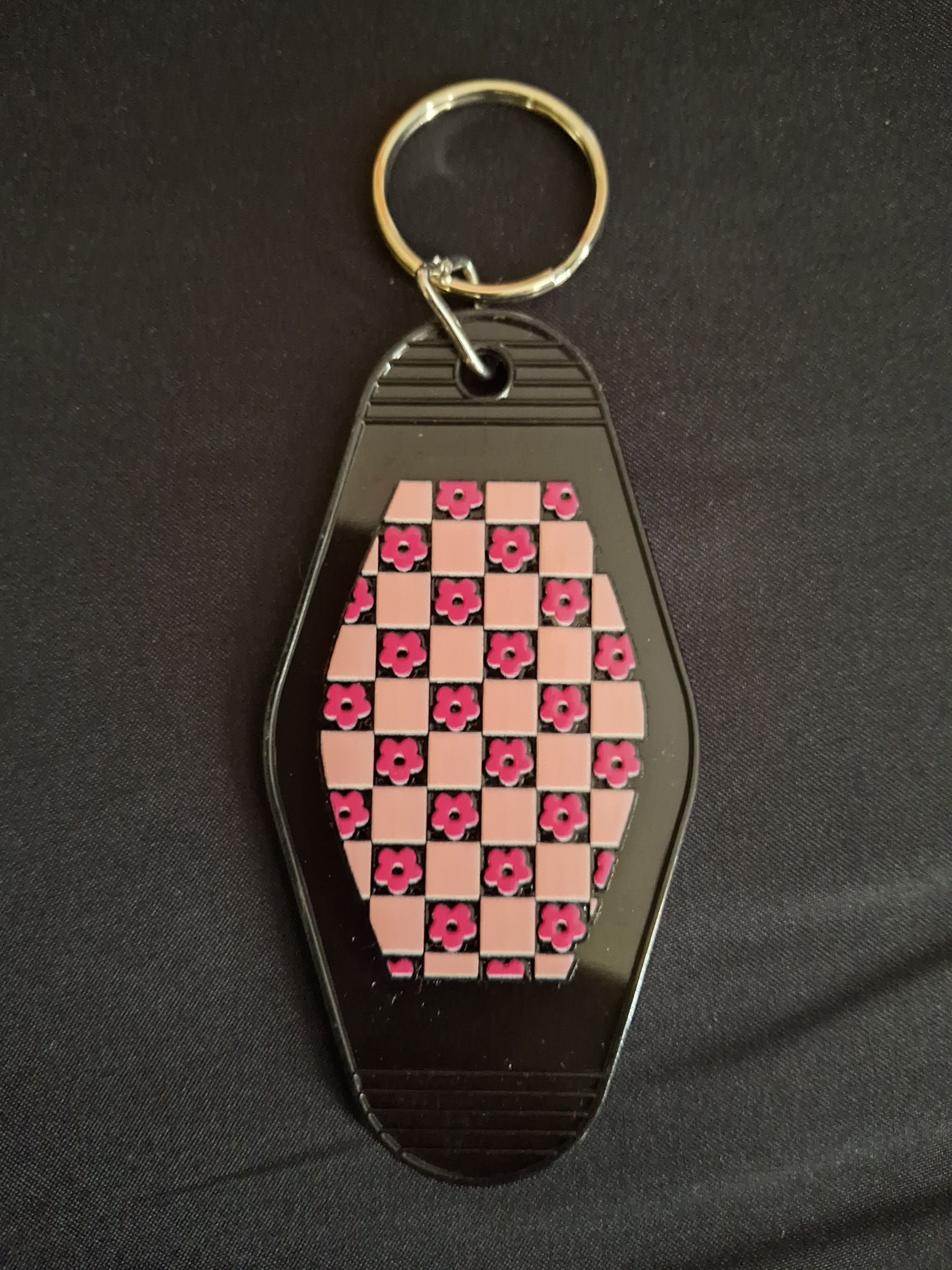 Keychain with checkered pattern on a dark background