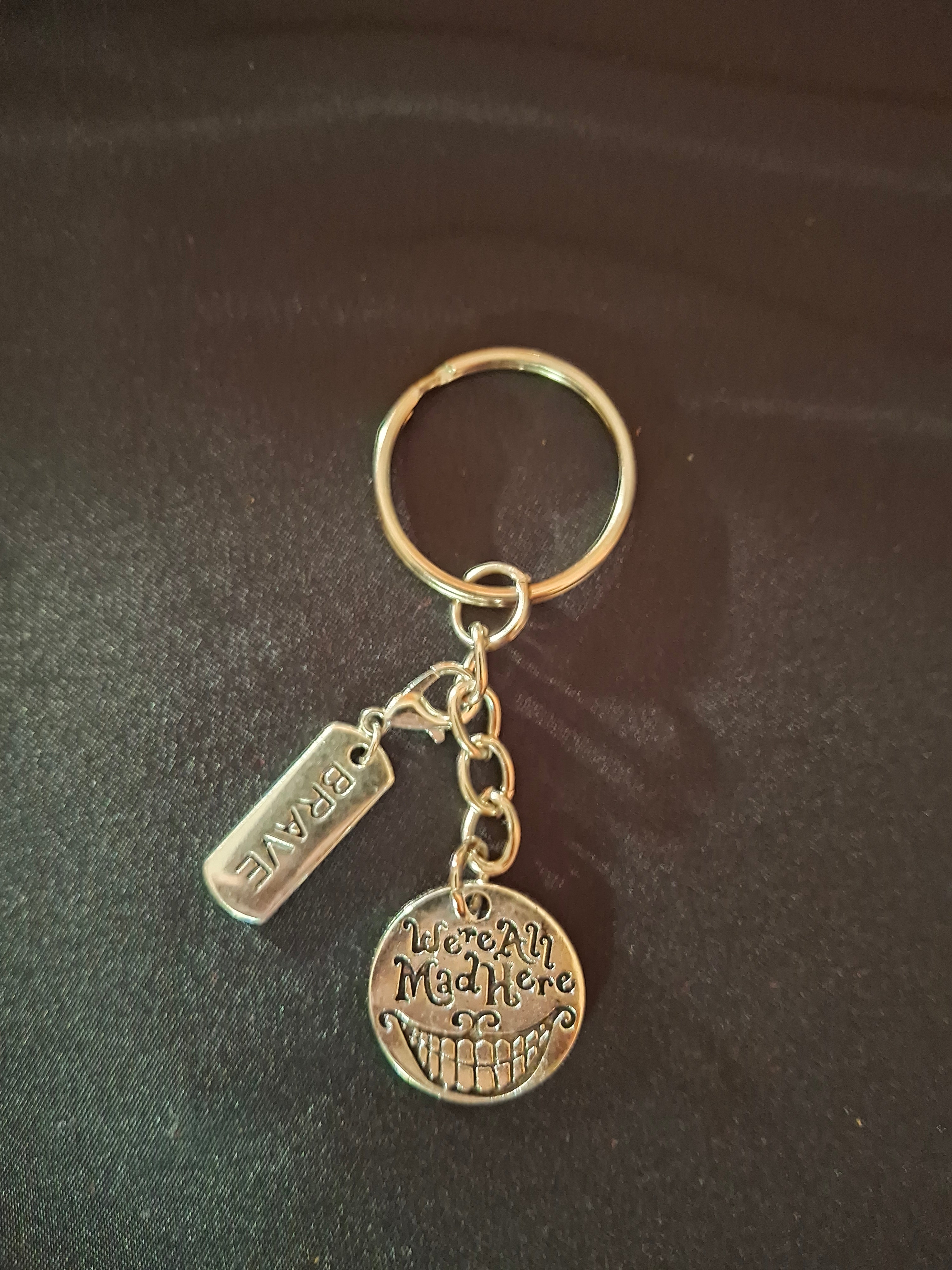 Keychain with two charms on a dark background