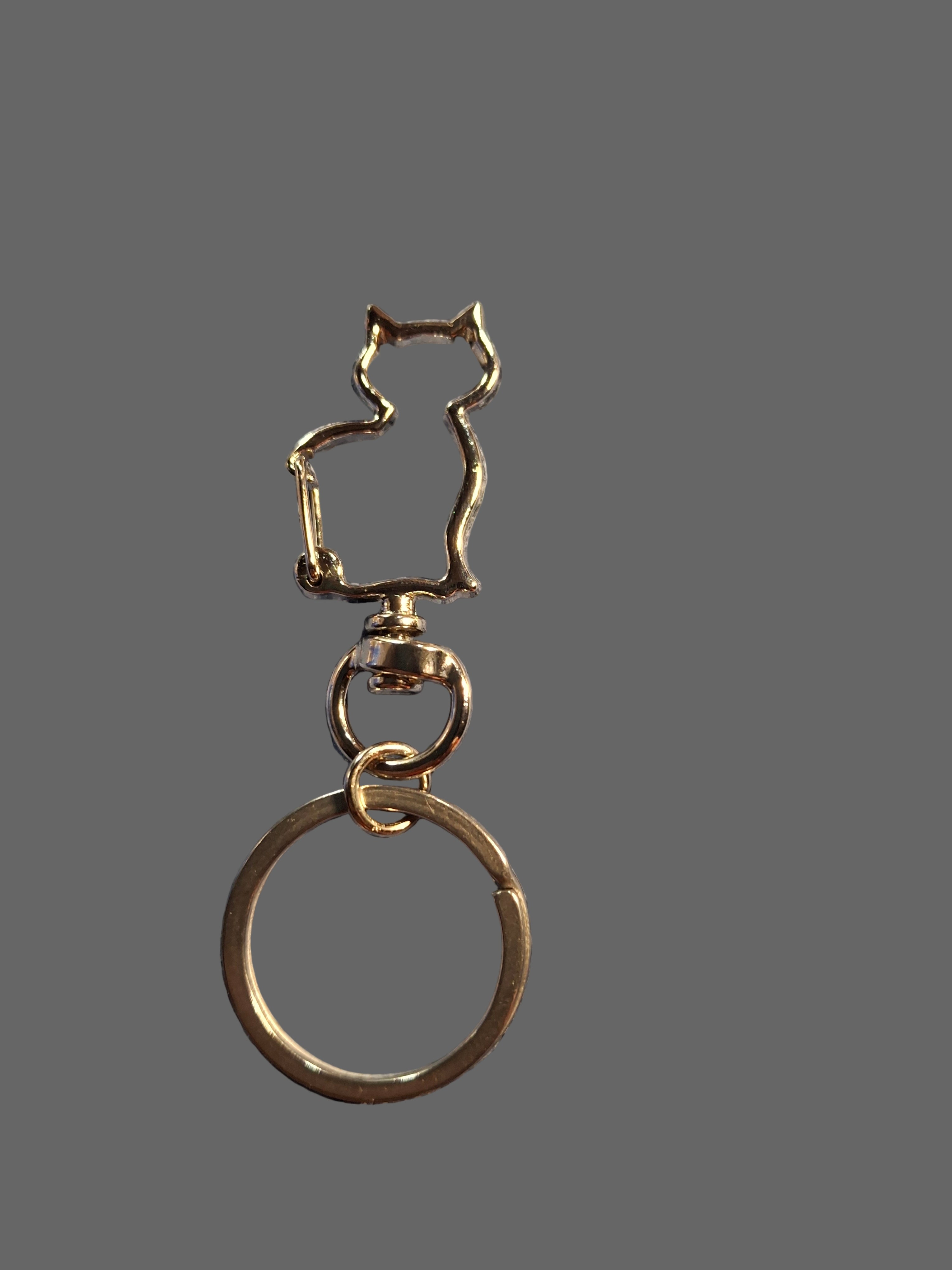 Metal keychain with a unique design on a textured gray surface