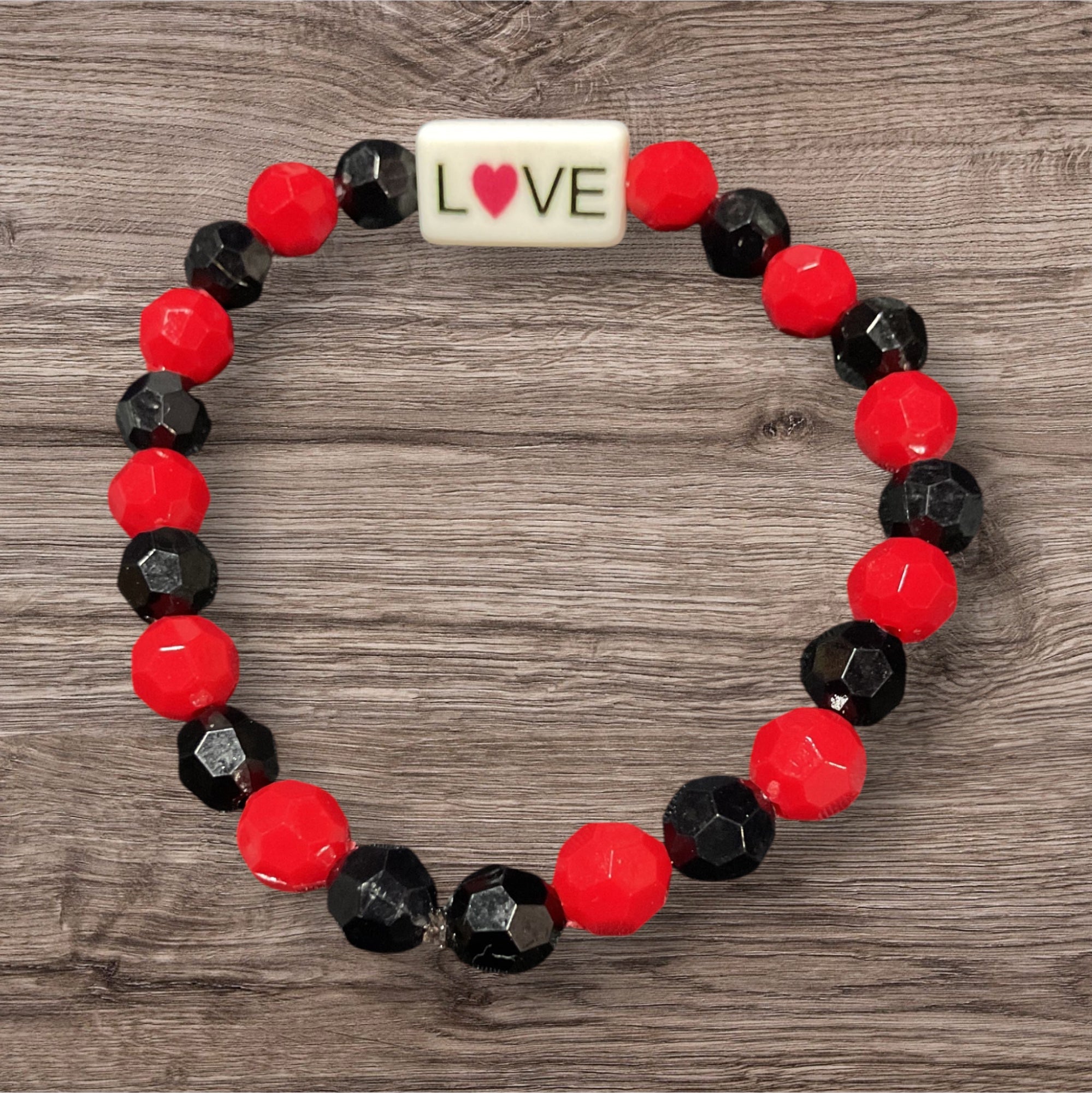 Red and black beads with love charm