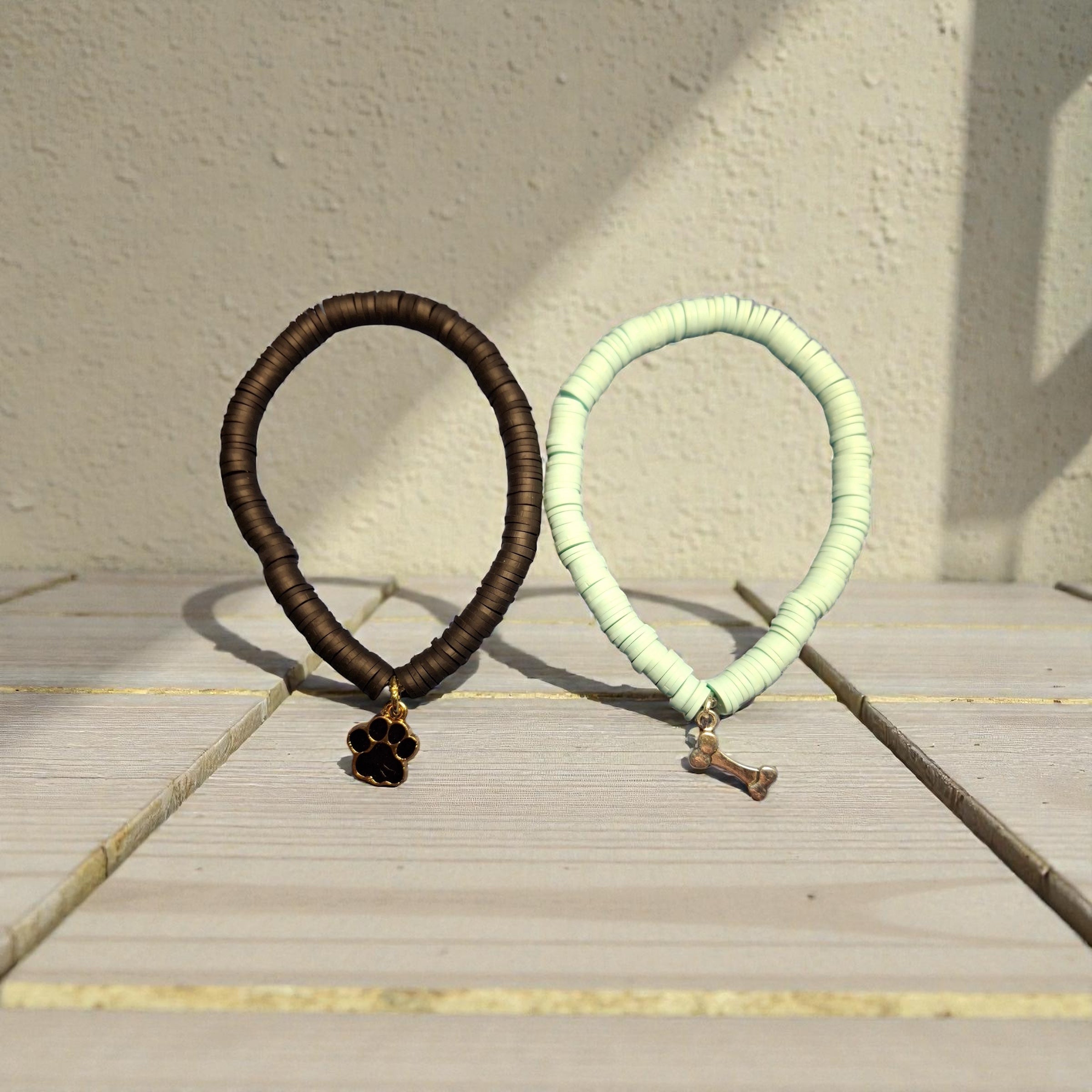 One Mint Green Bracelet with Bone Charm, One Black Bracelet with Paw Charm