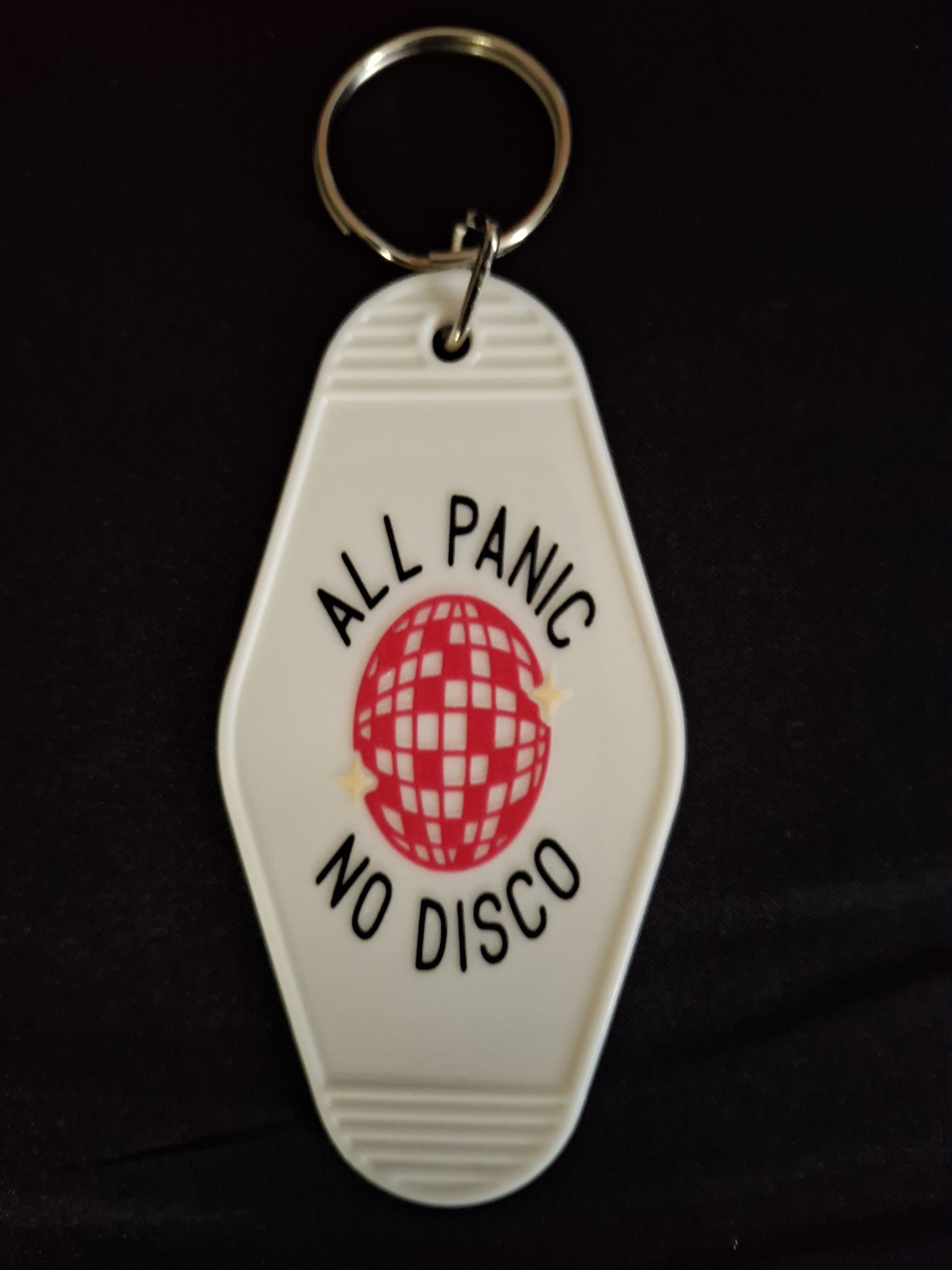 Keychain with 'All Panic At The Disco' logo on a black background