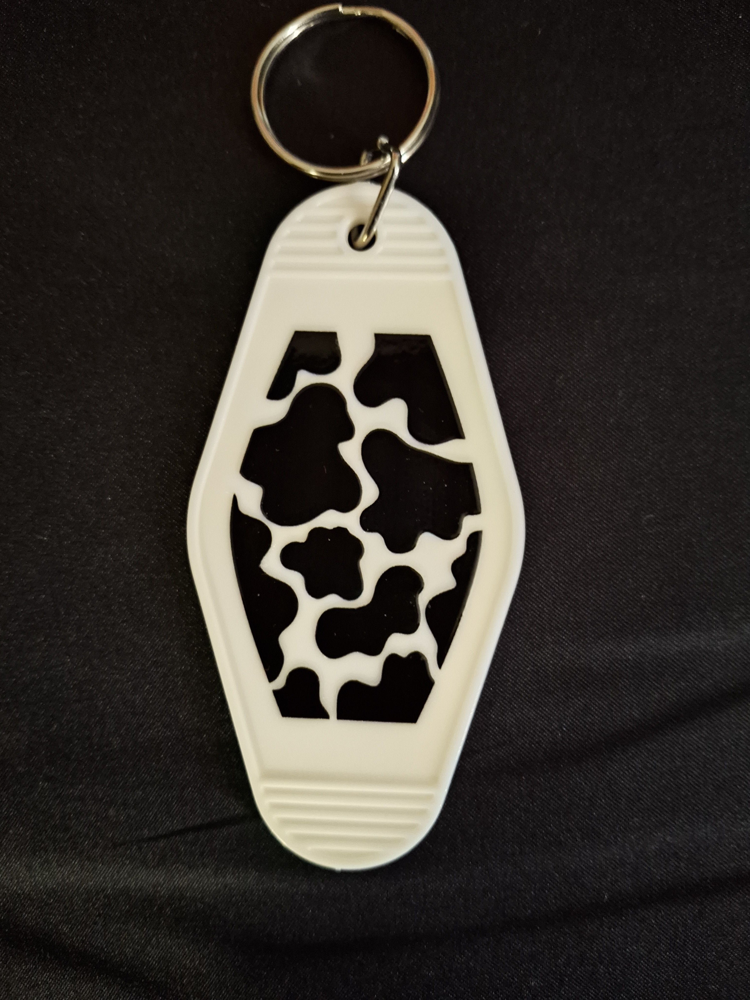 Cow print keychain on a black background