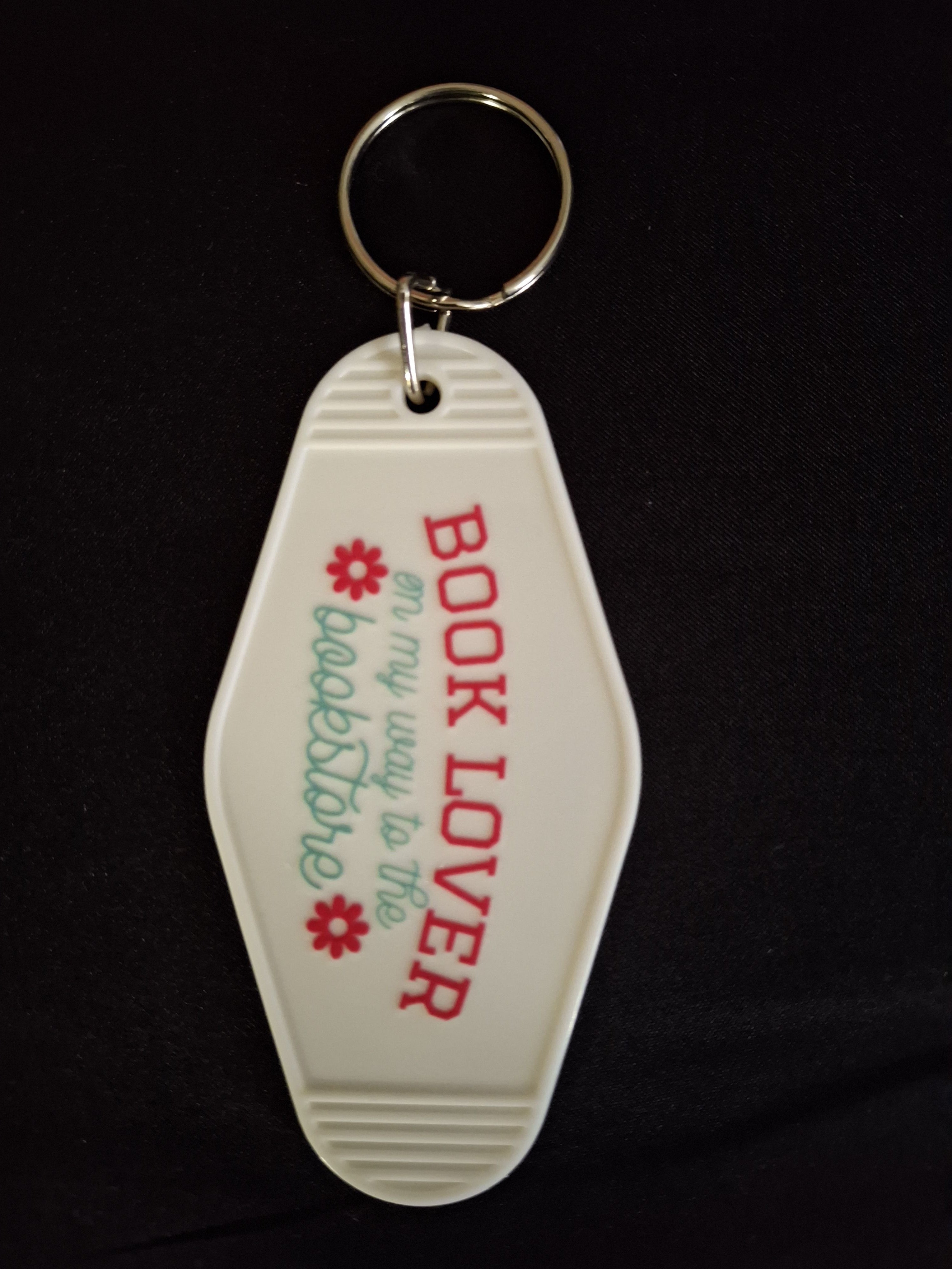 Keychain with 'Book Lover on my way to the bookstore' text on a black background