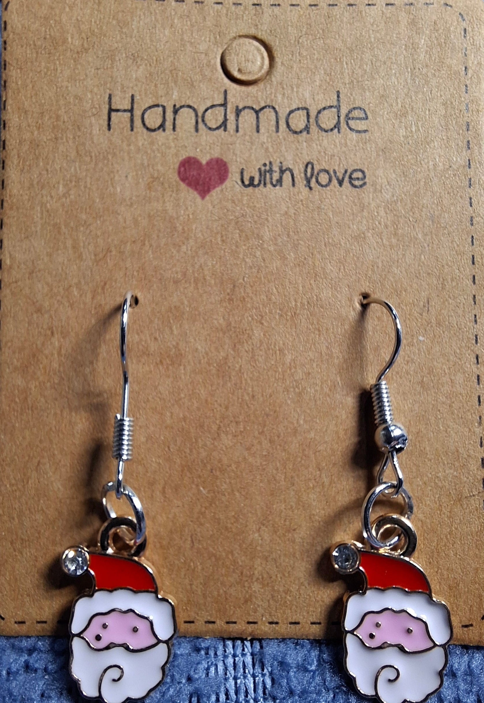 Handmade Santa Claus earrings on a brown card with 'Handmade with love' text.
