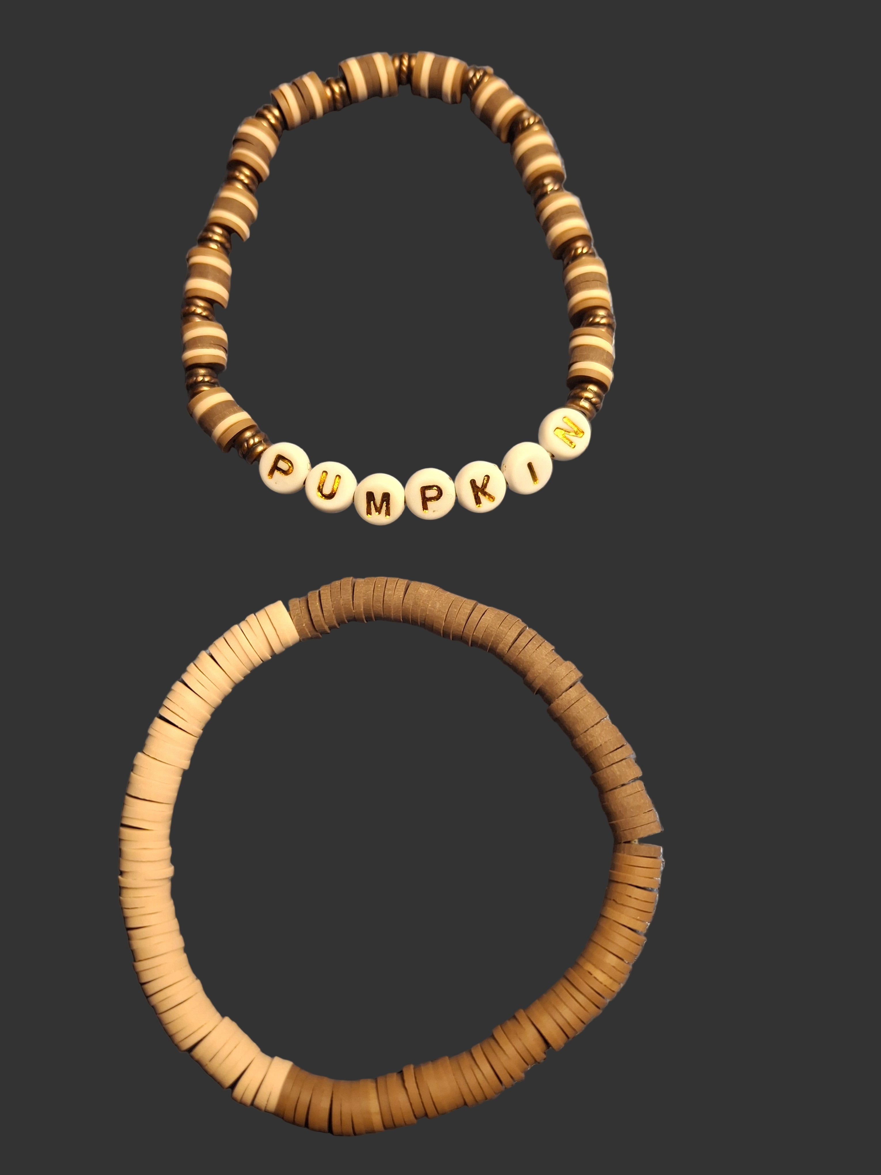 Two wooden beaded bracelets on a dark background