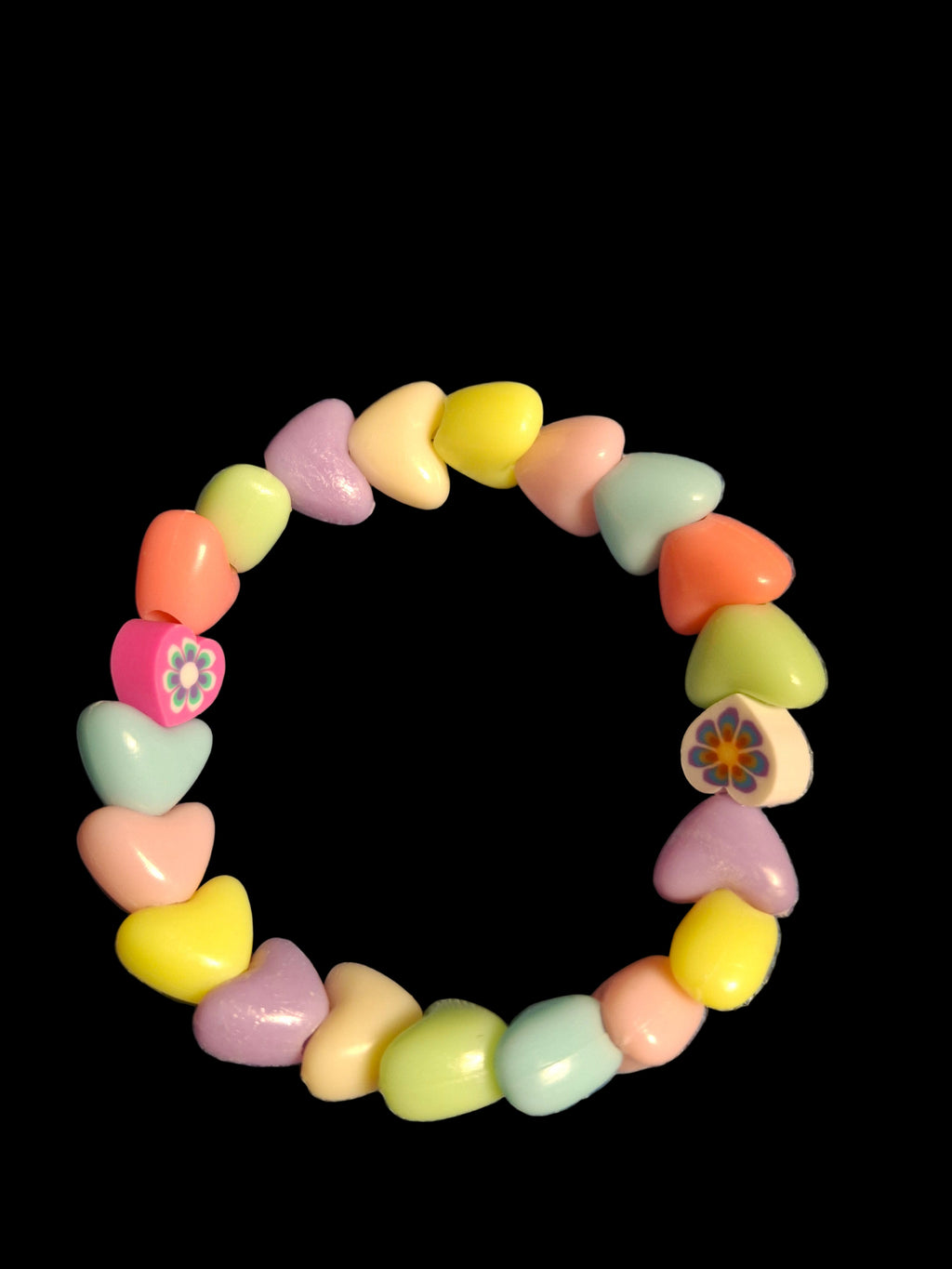 Colorful heart-shaped beaded bracelet on a black background