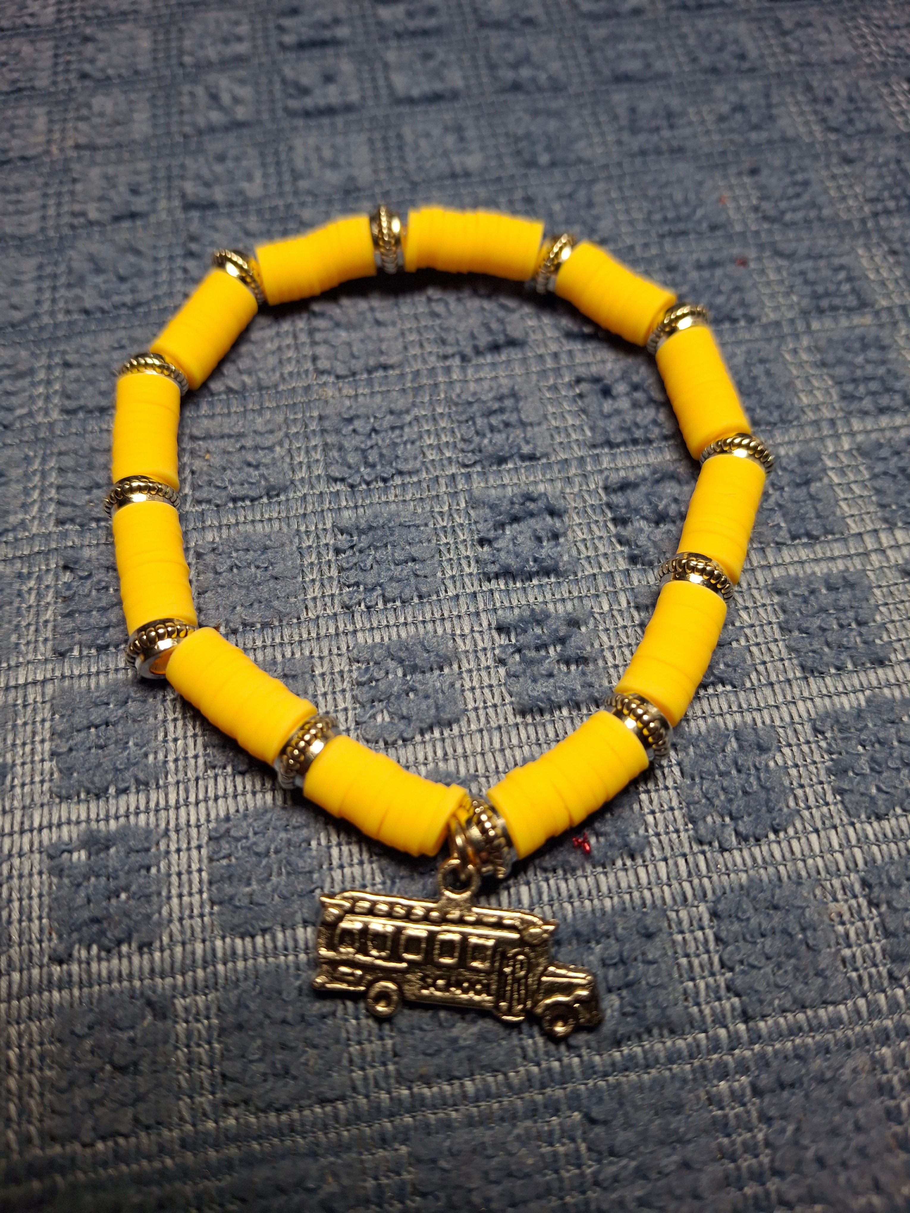 Yellow clay beads with schoolbus charm