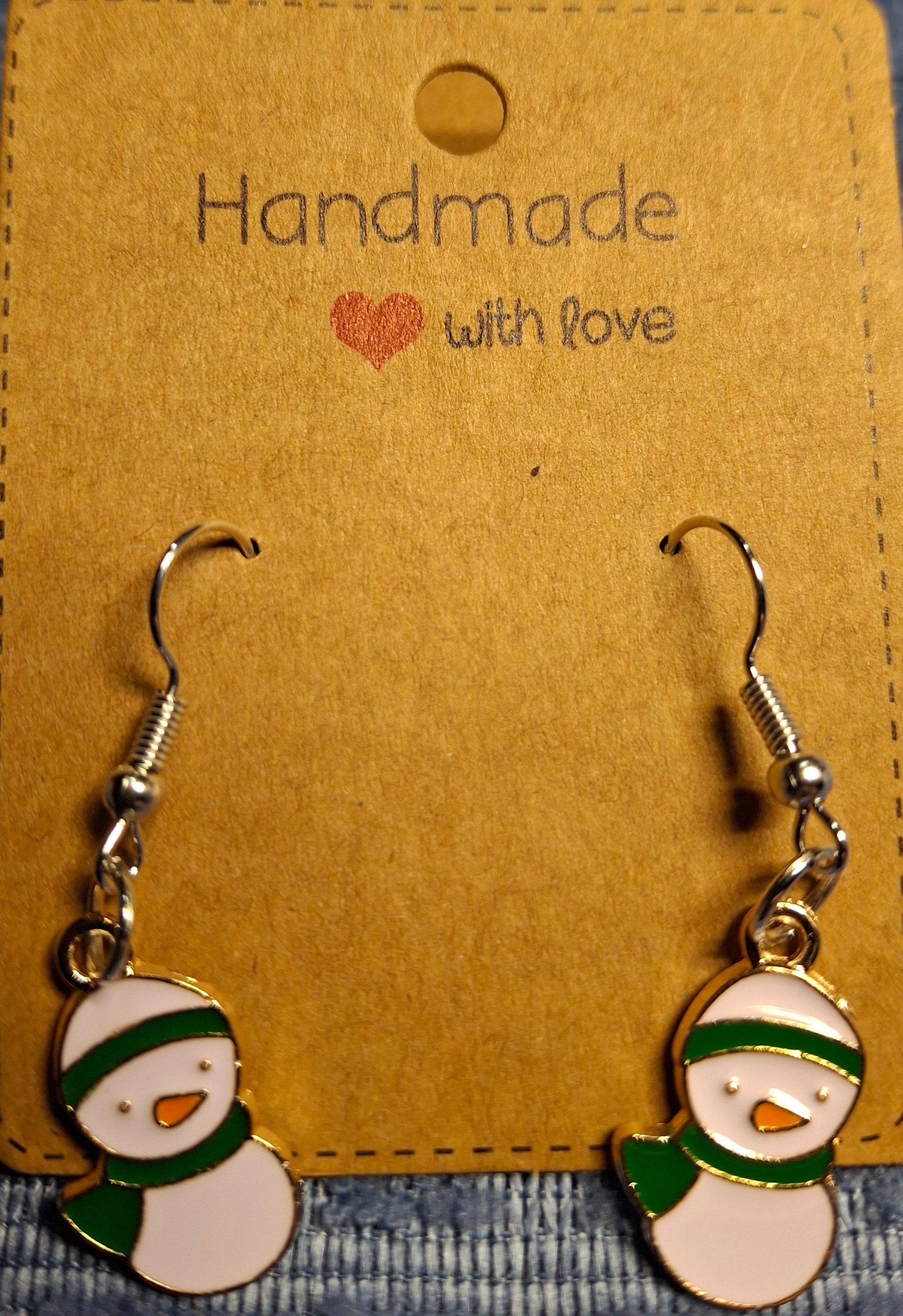 Snowman-shaped earrings on a 'Handmade with Love' card.