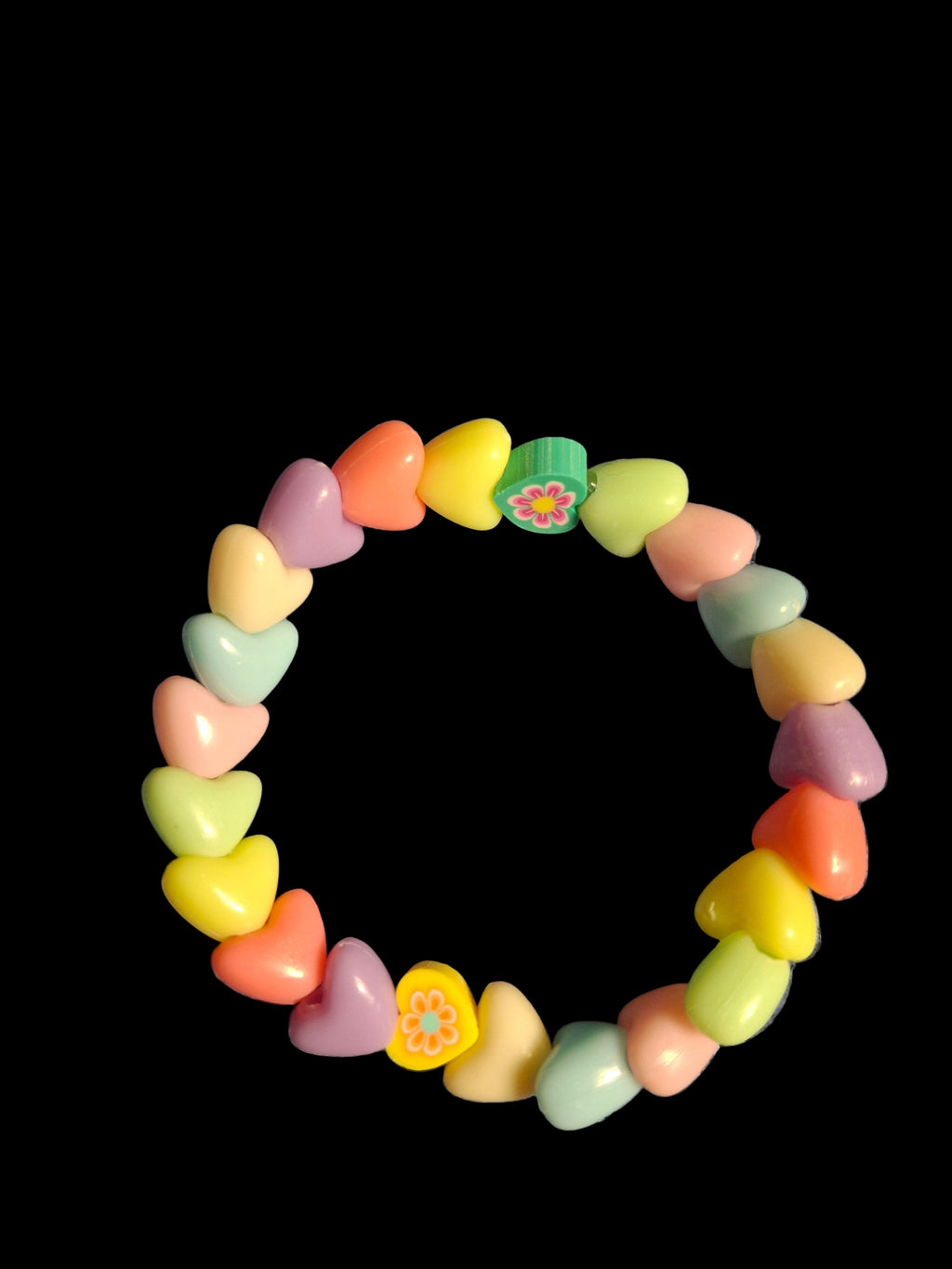 Colorful heart-shaped beaded bracelet on a black background