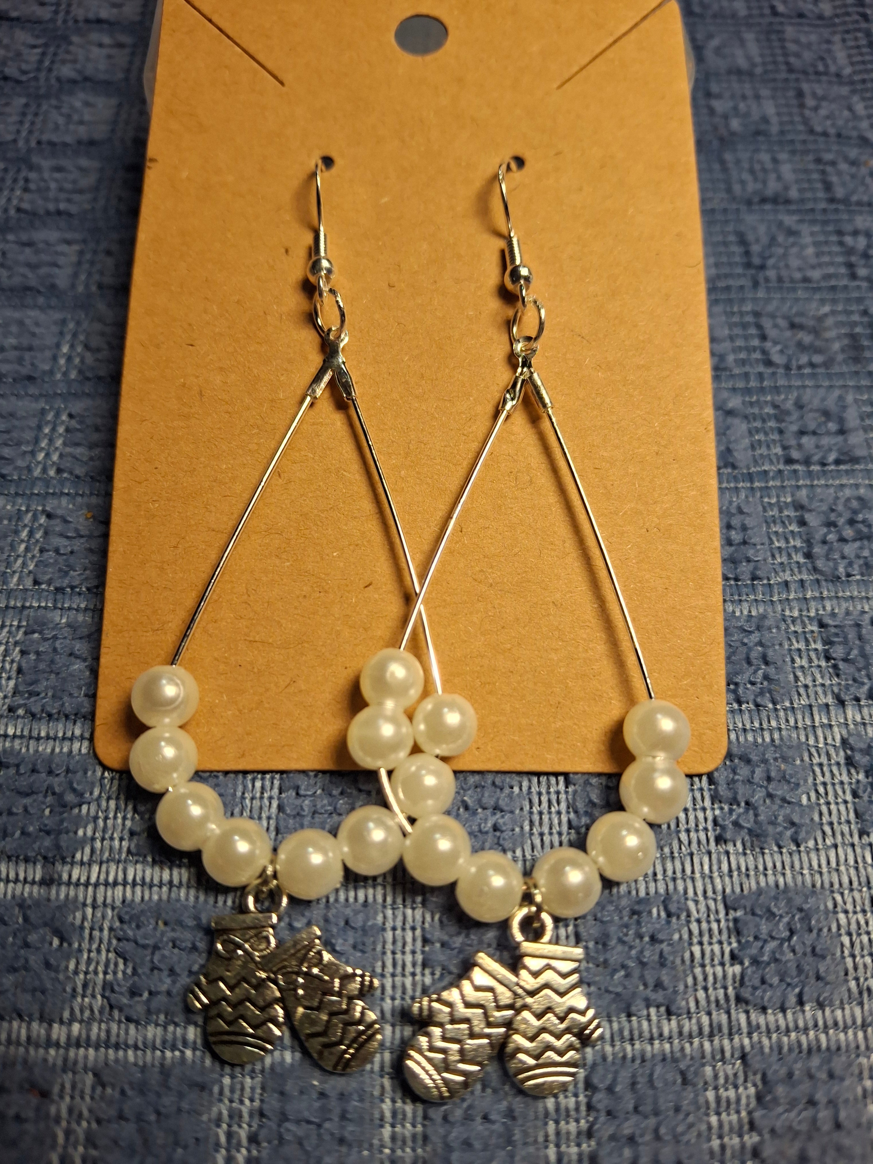 White beads with glove charms