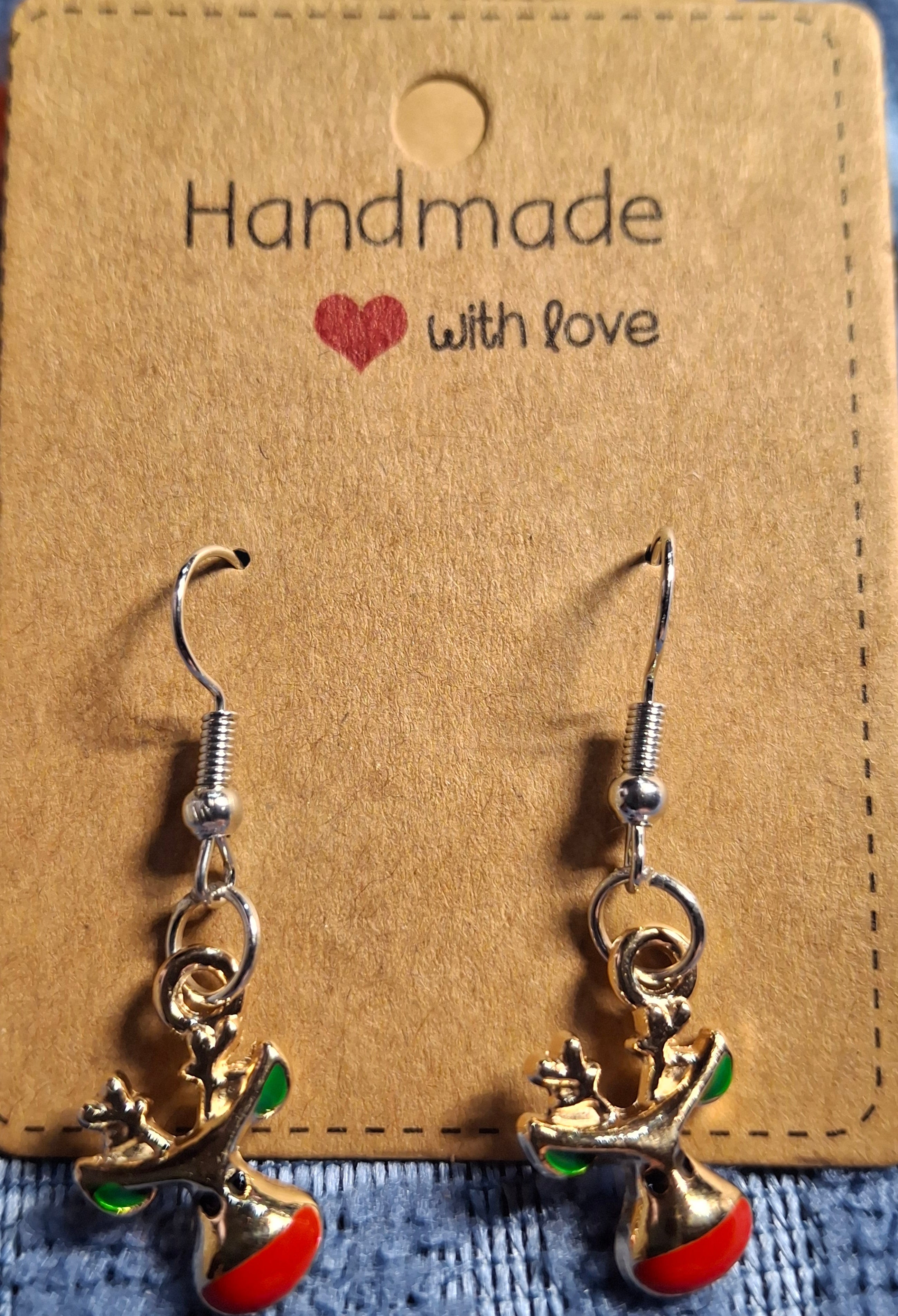 Handmade earrings with red and green accents on a brown card labeled 'Handmade with love'.