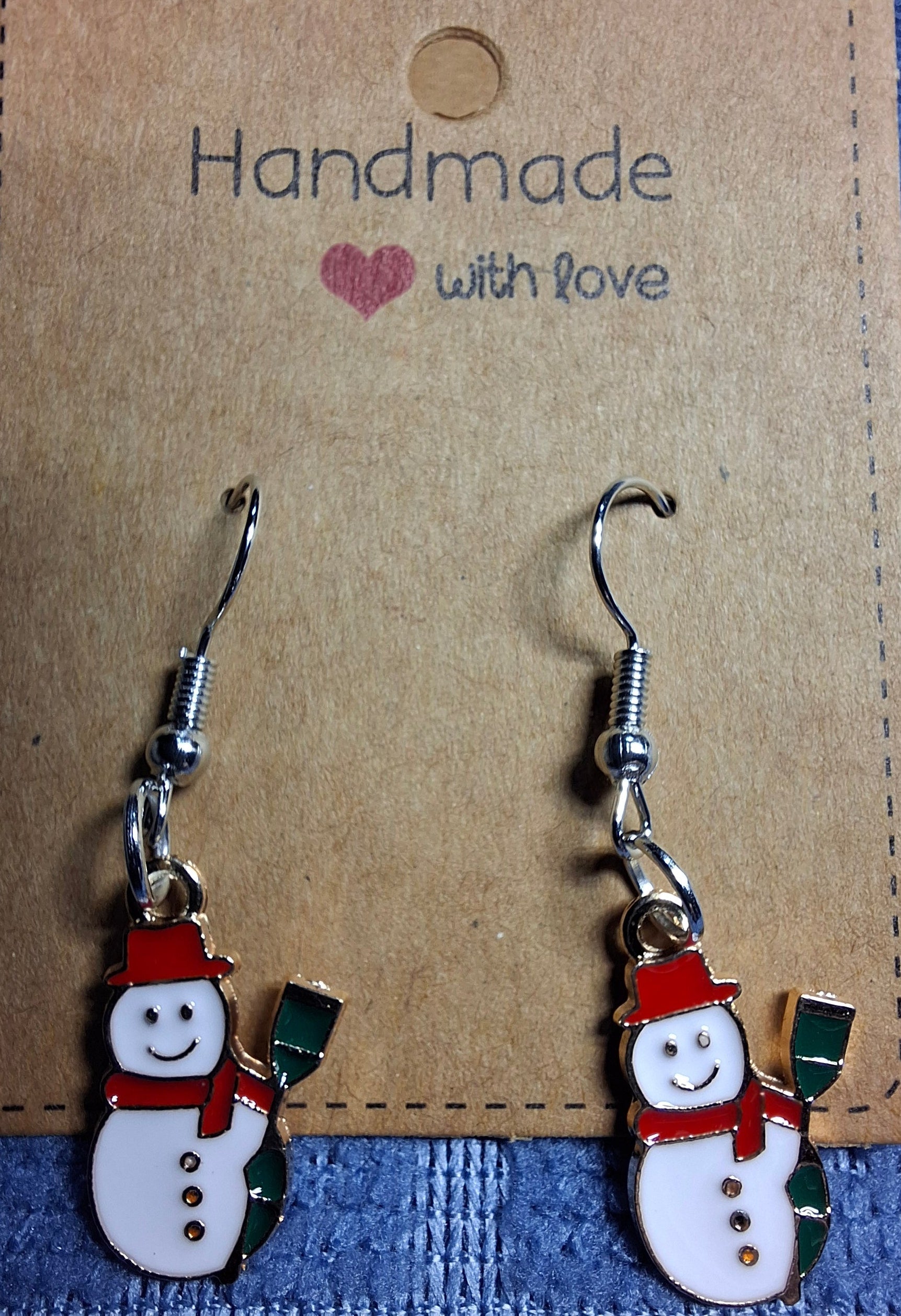 Snowman-shaped earrings on a 'Handmade with Love' card.