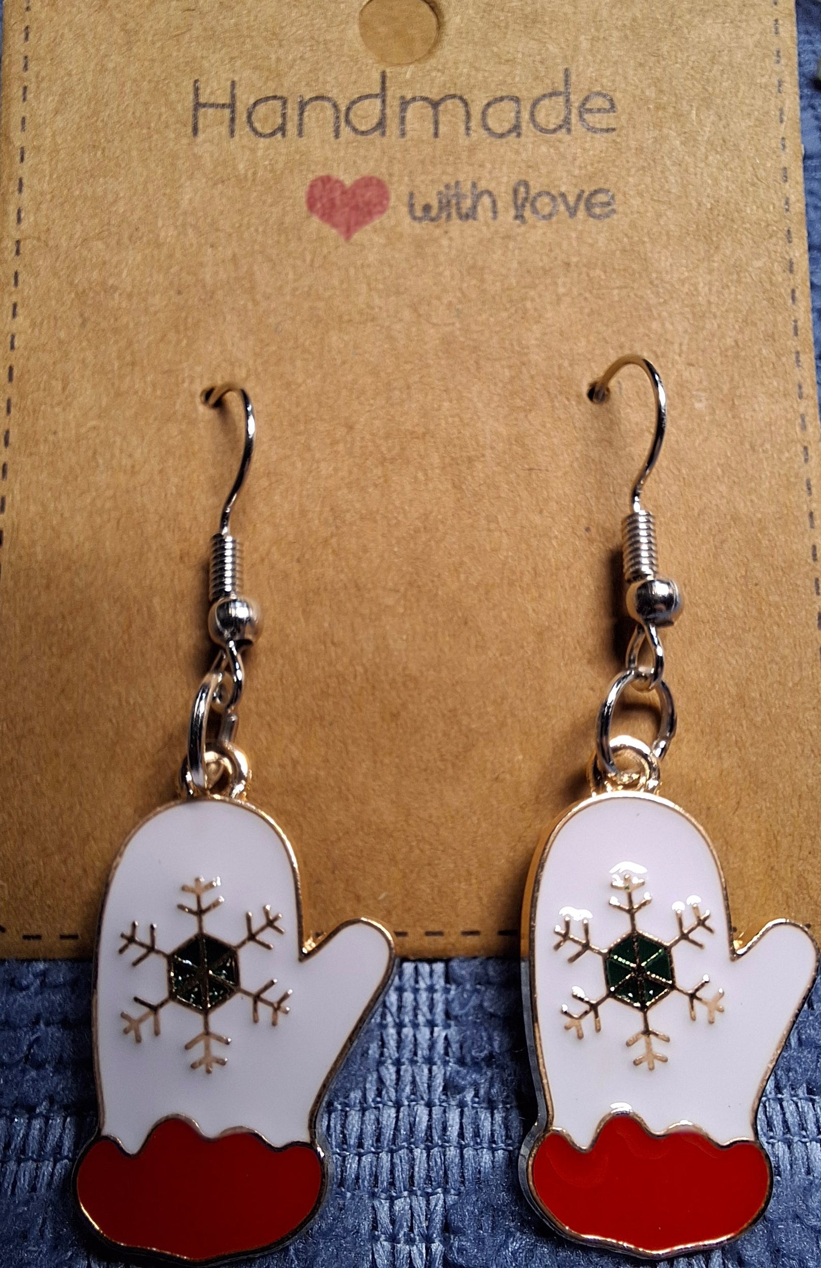Handmade earrings with snowflake design on a brown card